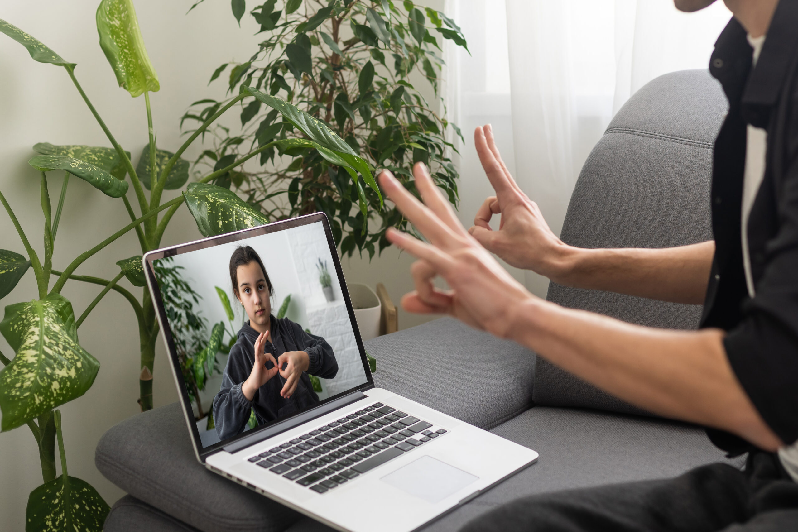 A remote ASL interpreting services in a video call, using American Sign Language (ASL).