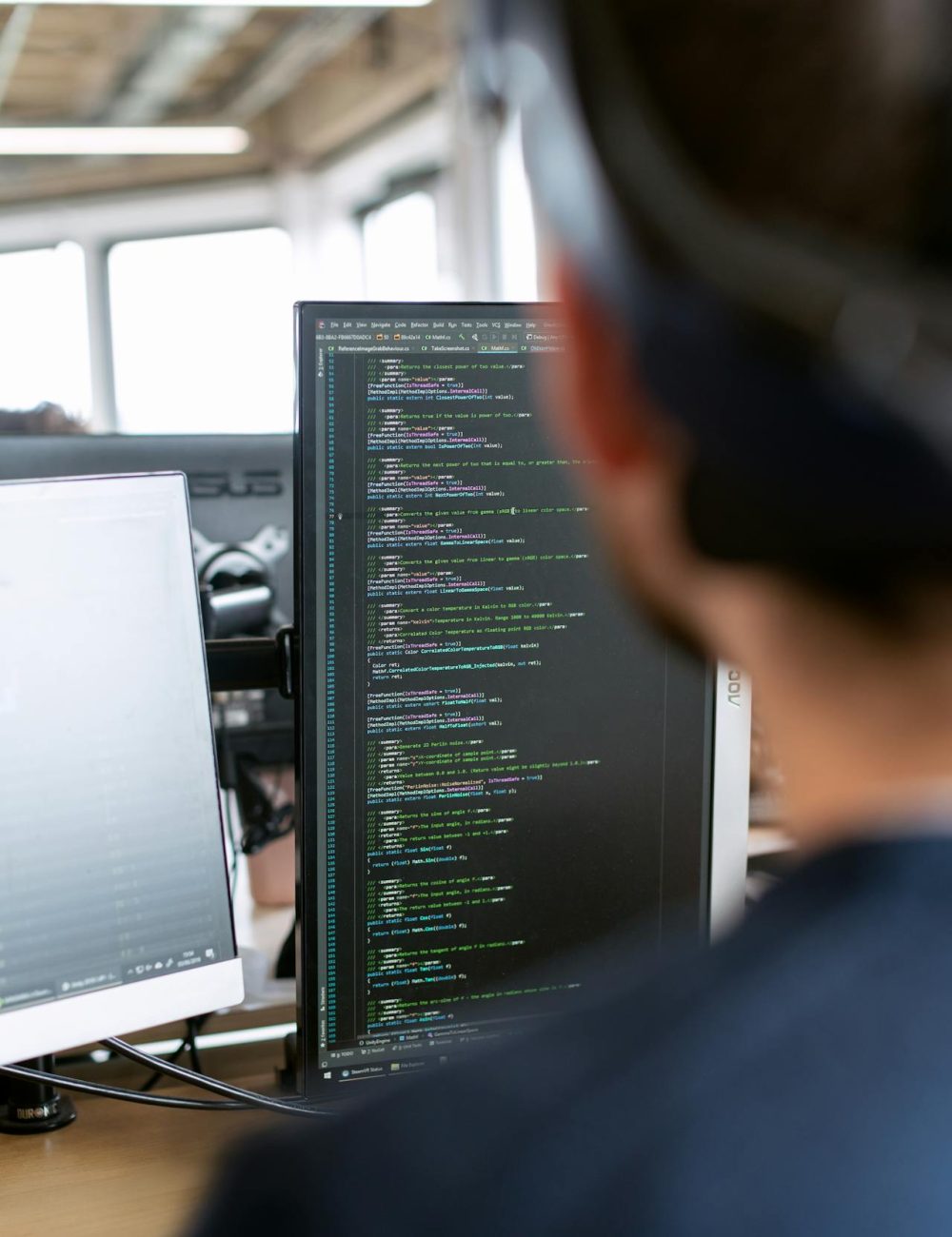 man in black shirt sitting in front of computer seeking codes for marketing translation